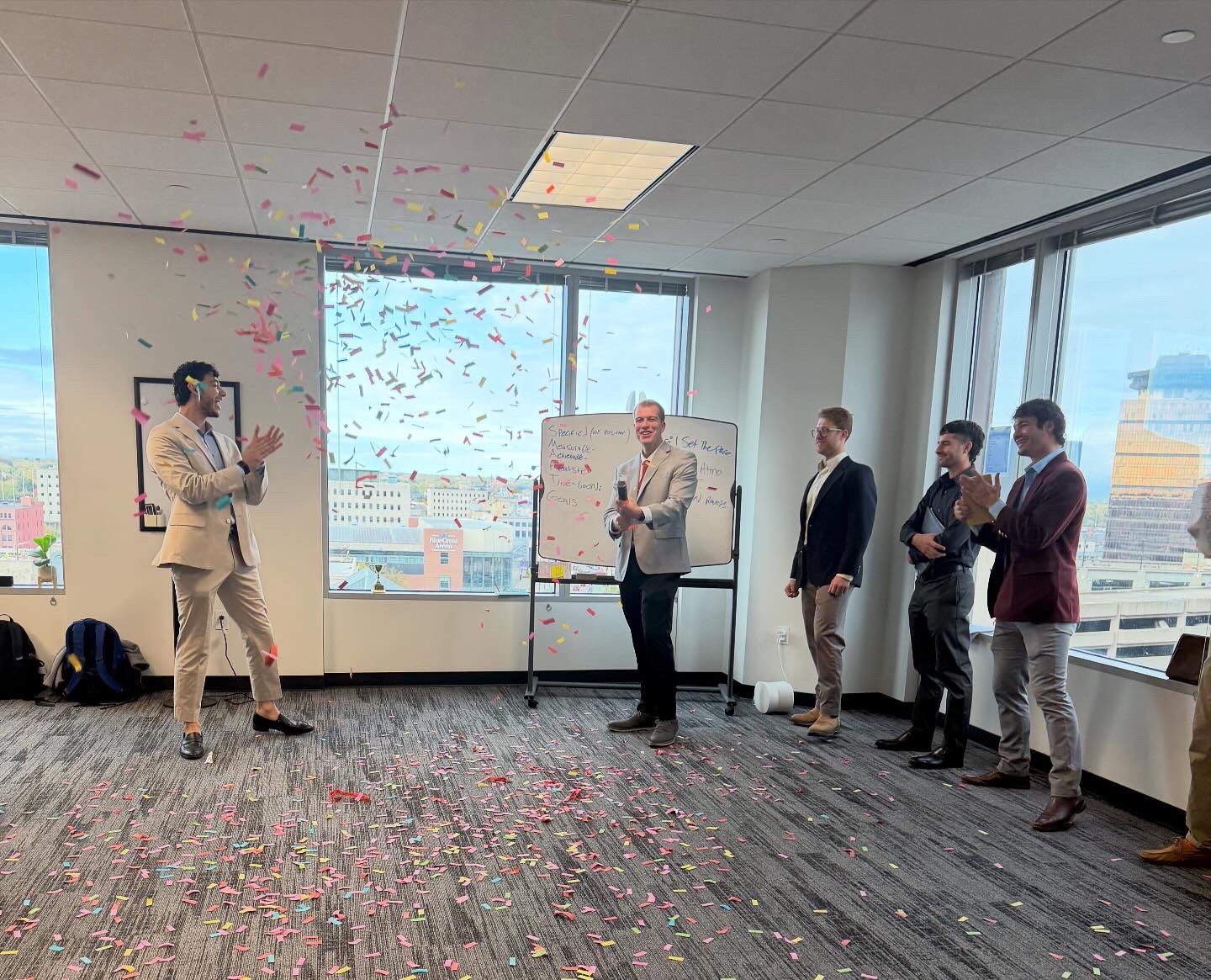 Tiber and Laurel team celebrating with confetti in the Rochester office
